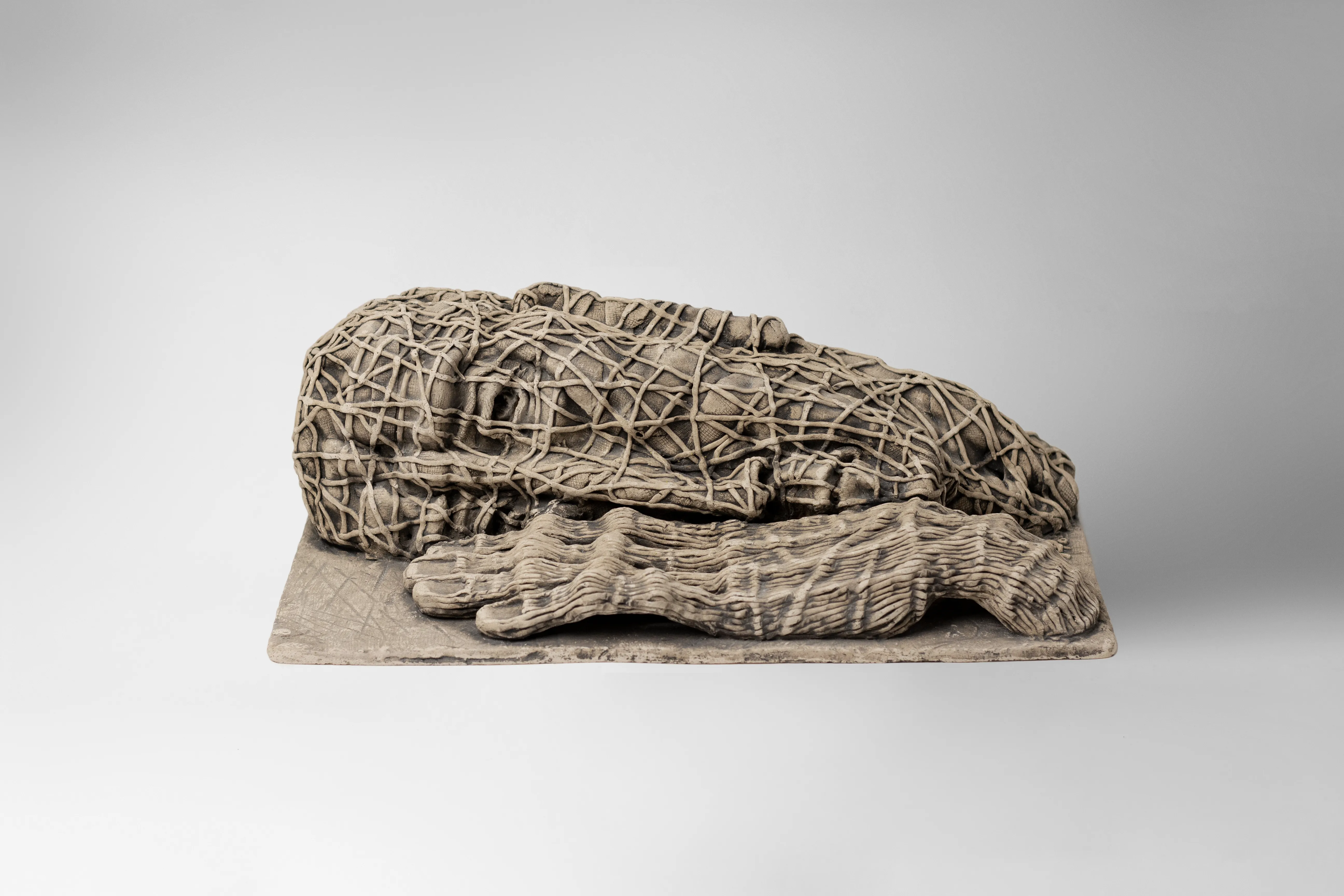 Image of The one who lying down by Liudmyla Davydenko, size: 38х21х12, made of chamotte, glaze, Sculpture medium, part of the Holova/Head series, priced at €1000